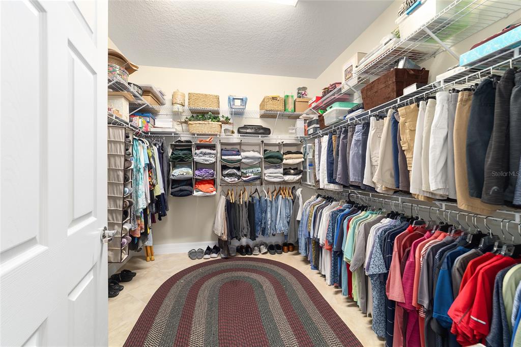 9603 Southwest 67th Street Ocala, FL 34481 - Photo 31 of 63 a view of walk in closet with clothes and shoes