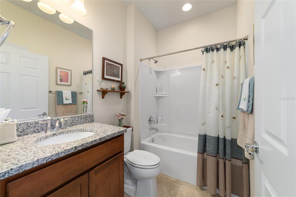 9603 Southwest 67th Street Ocala, FL 34481 - Photo 38 of 63 a bathroom with a granite countertop sink toilet and shower