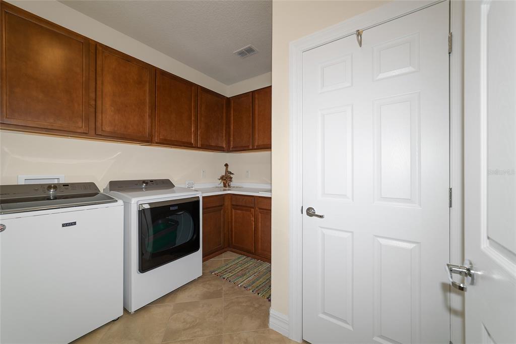 9603 Southwest 67th Street Ocala, FL 34481 - Photo 40 of 63 a view of a kitchen with sink and washing machine