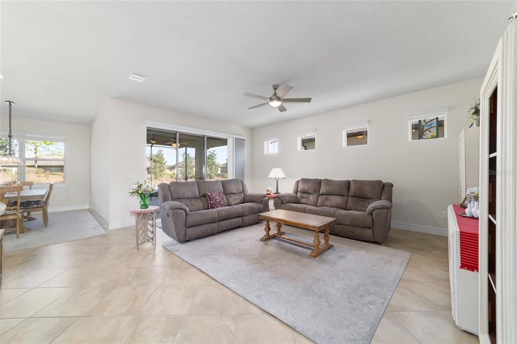 9603 Southwest 67th Street Ocala, FL 34481 - Photo 8 of 63 a living room with furniture and a large window