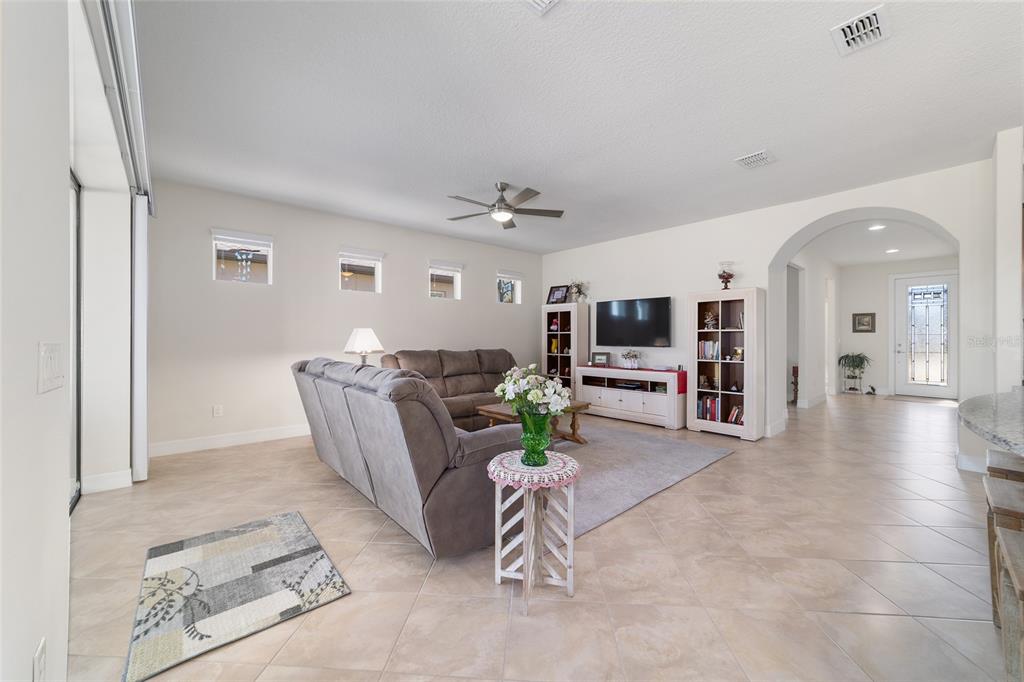 9603 Southwest 67th Street Ocala, FL 34481 - Photo 9 of 63 a living room with furniture and a flat screen tv