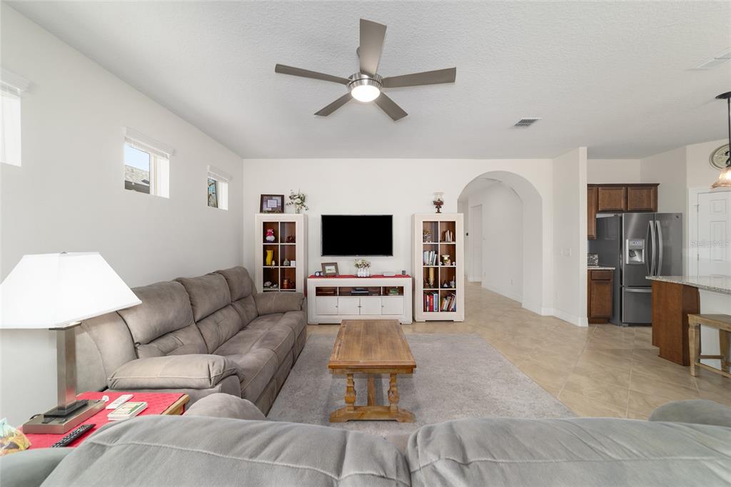9603 Southwest 67th Street Ocala, FL 34481 - Photo 10 of 63 a living room with furniture and a flat screen tv