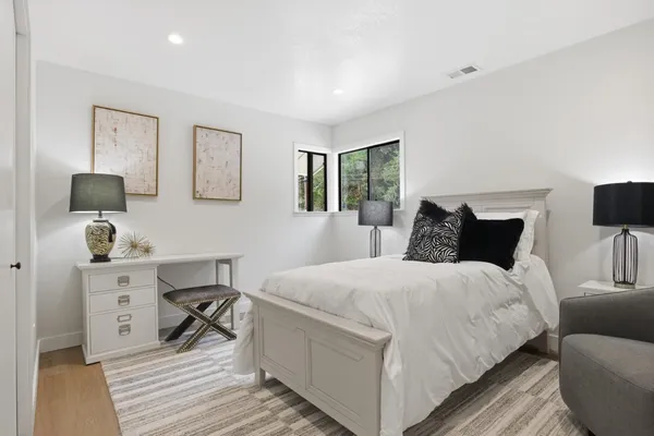 a bedroom with a bed and a desk