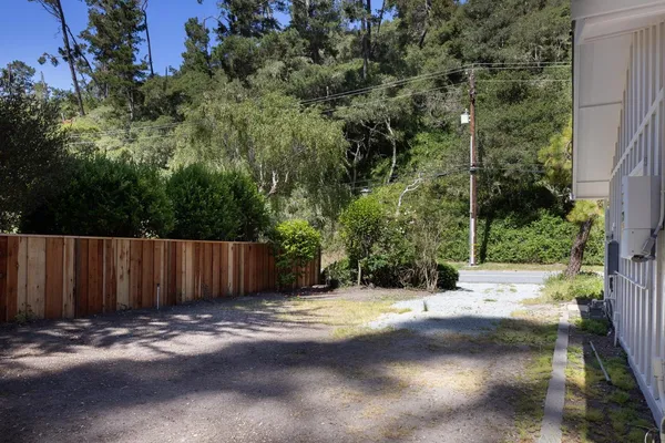 a view of wooden fence next to a road