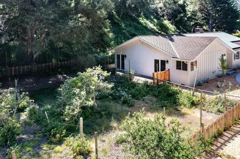 a aerial view of a house with a yard and sitting area