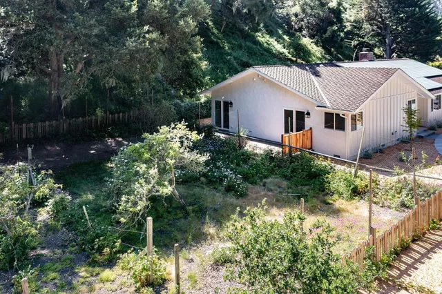 a aerial view of a house with a yard and sitting area