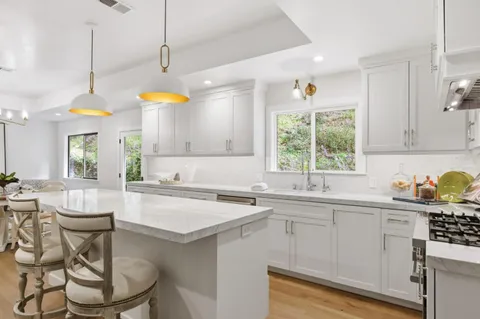 a kitchen with a sink stove and cabinets