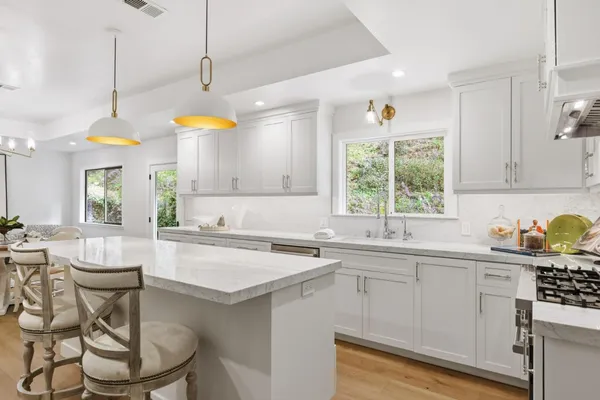 a kitchen with a sink stove and cabinets