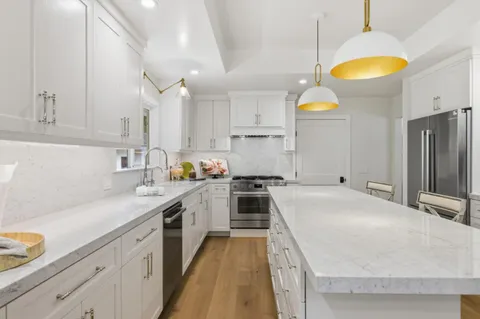 a kitchen with cabinets and wooden floor