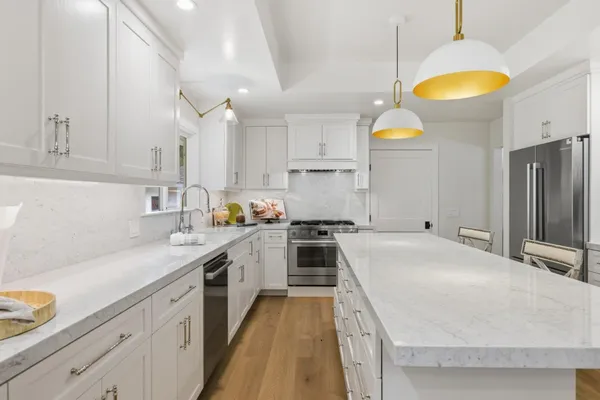 a kitchen with cabinets and wooden floor