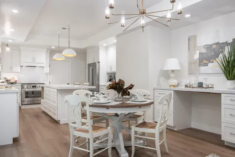 a kitchen with a center island a sink cabinets and wooden floor