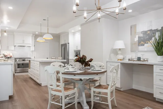a kitchen with a center island a sink cabinets and wooden floor
