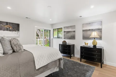 a bedroom with a bed and dresser with window