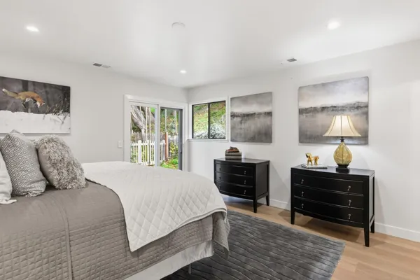 a bedroom with a bed and dresser with window