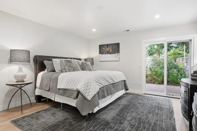 a bedroom with a bed and glass window