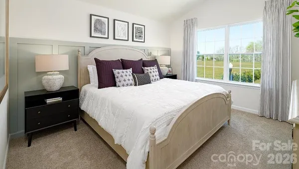 a spacious bedroom with a bed and window