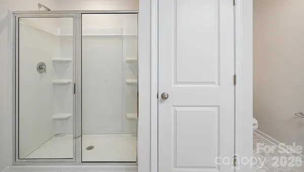 a bathroom with a glass shower door