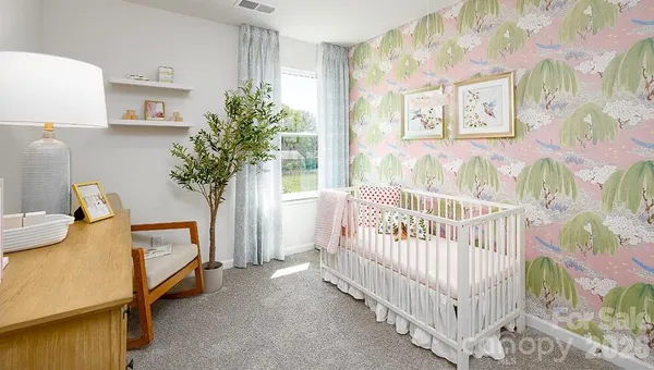 a bedroom with furniture and a baby crib