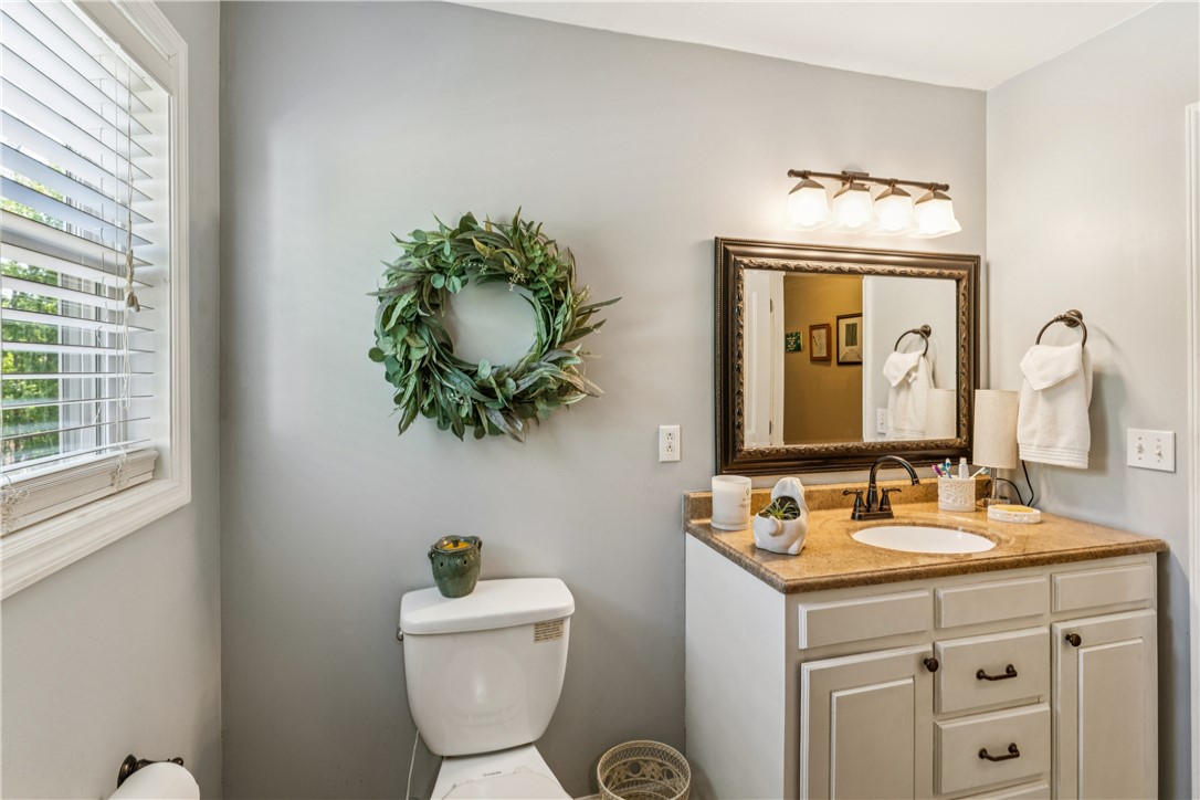 189 Little Choestoea Road Westminster, SC 29693 - Photo 21 of 38 This bathroom features an elegant vanity with a large mirror and bright lighting.