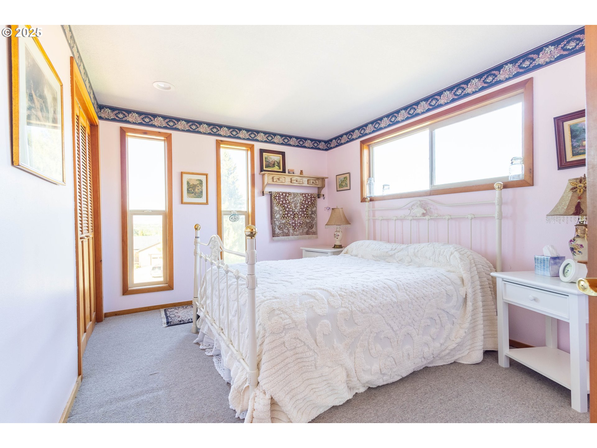 1902 Highland Drive La Grande, OR 97850 - Photo 37 of 46 a bedroom with a bed next to a window with a flat screen tv