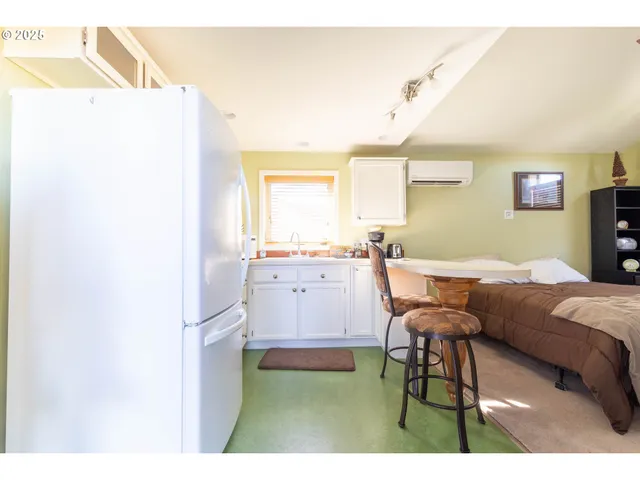a living room with furniture a dining table and a fireplace
