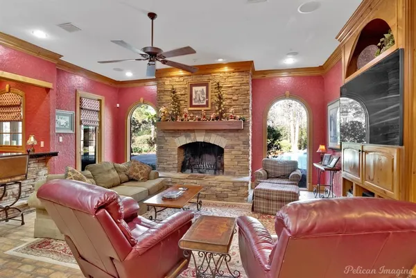a living room with furniture a fireplace and a chandelier