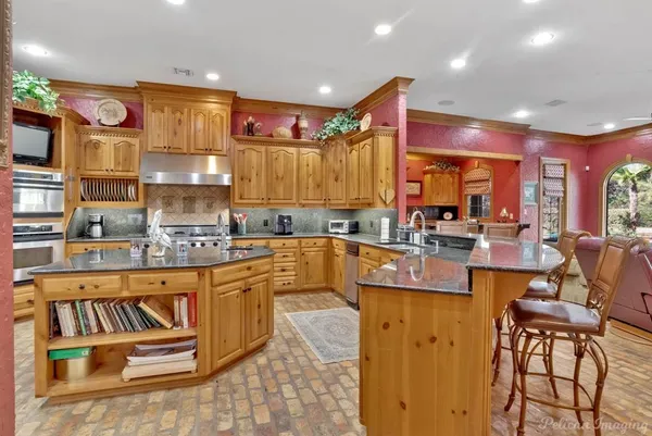 a large kitchen with a table and chairs