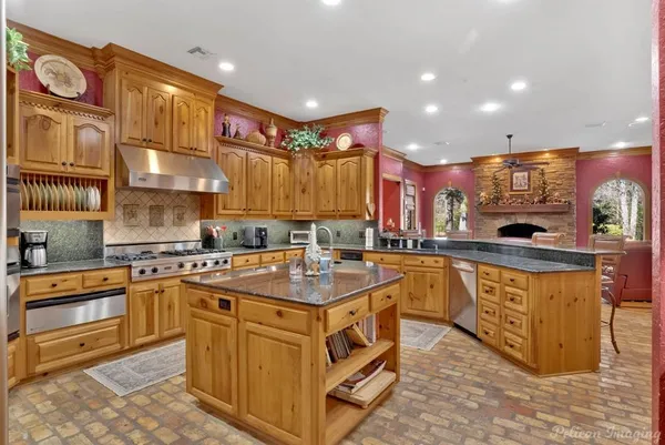 a kitchen with stainless steel appliances granite countertop a sink and cabinets