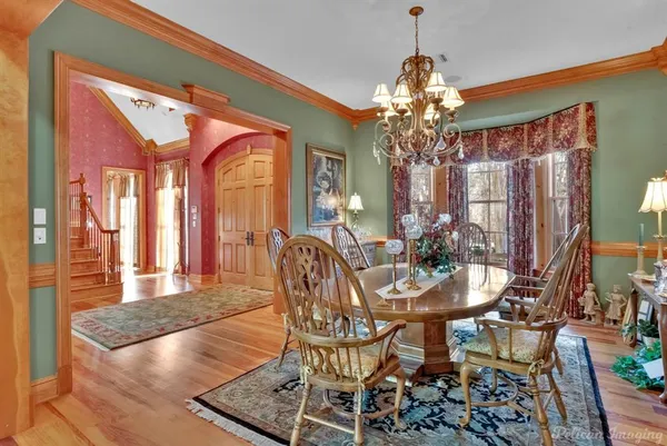 a view of a dining room with furniture and chandelier
