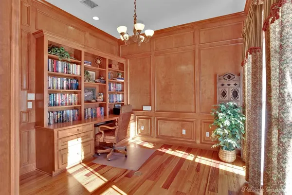 a view of a workspace with furniture and a chandelier