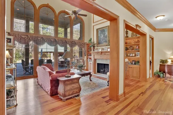 a living room with fireplace furniture and a floor to ceiling window