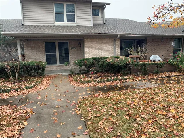 a front view of a house with lots of green space