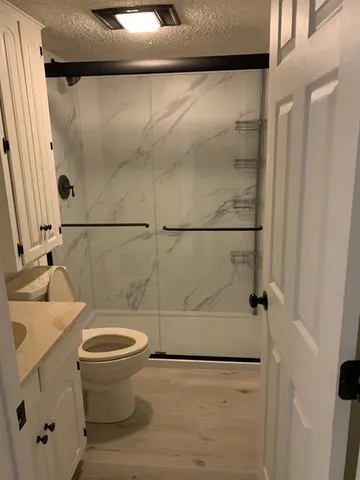 a view of a room with wooden floor and window