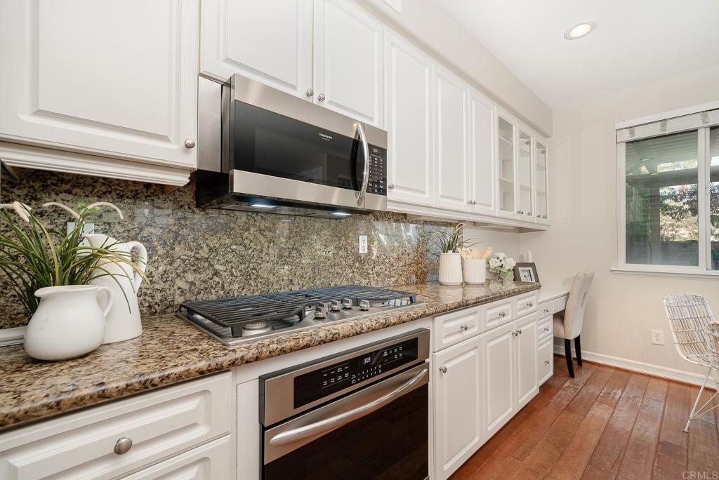 5406 Foxtail Loop Carlsbad, CA 92010 - Photo 16 of 50 a kitchen with stainless steel appliances granite countertop a sink a stove and a microwave
