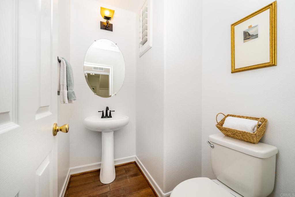 5406 Foxtail Loop Carlsbad, CA 92010 - Photo 18 of 50 a bathroom with a toilet sink and mirror