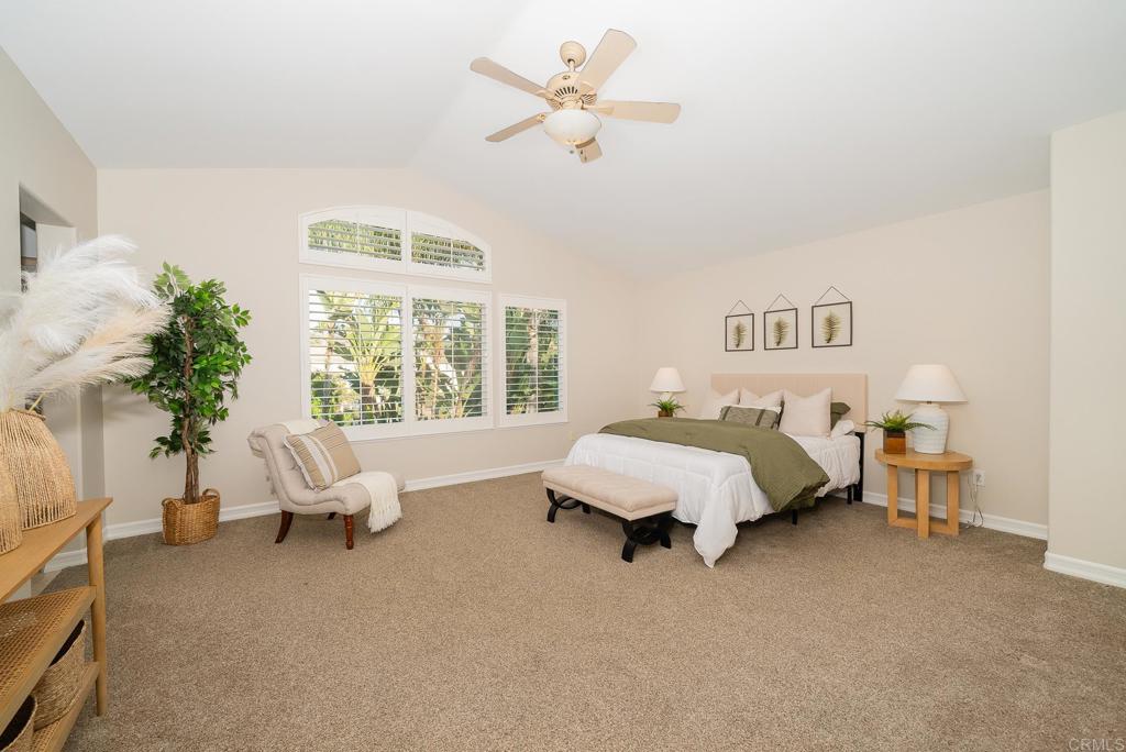 5406 Foxtail Loop Carlsbad, CA 92010 - Photo 21 of 50 a spacious bedroom with a bed and a couch