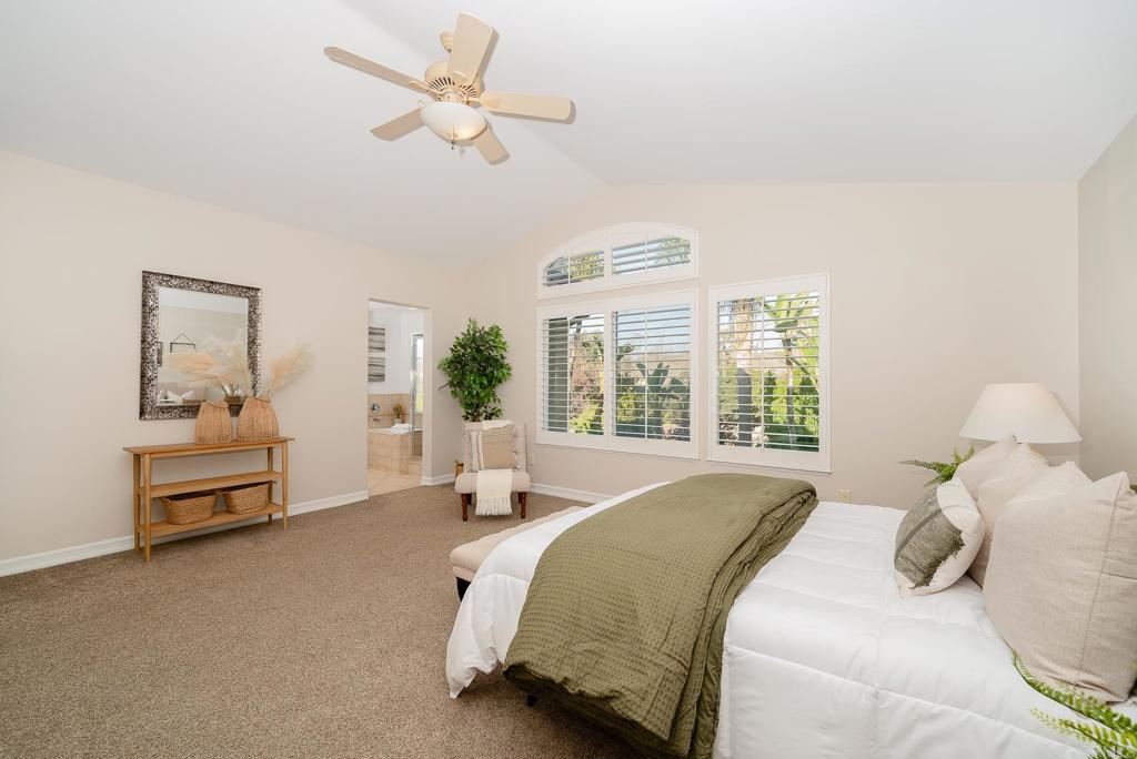 5406 Foxtail Loop Carlsbad, CA 92010 - Photo 22 of 50 a bedroom with a bed couch and window