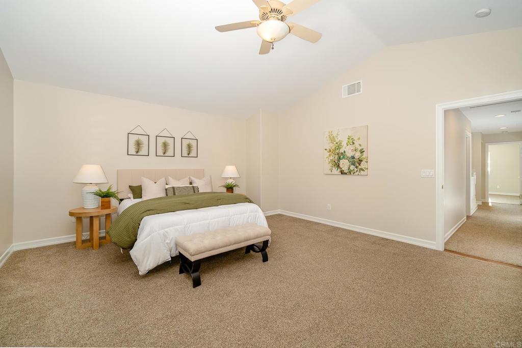 5406 Foxtail Loop Carlsbad, CA 92010 - Photo 23 of 50 a bedroom with a bed and a chandelier