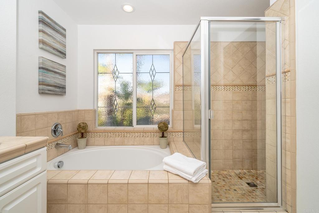 5406 Foxtail Loop Carlsbad, CA 92010 - Photo 25 of 50 a bathroom with a bathtub and shower