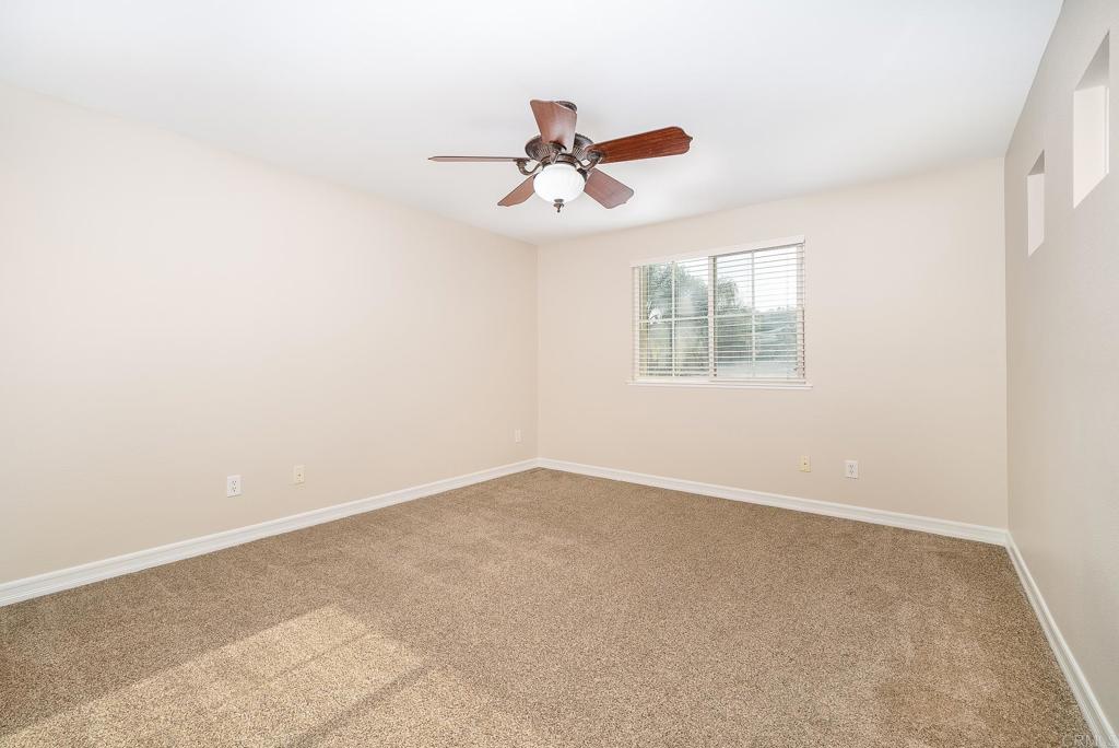 5406 Foxtail Loop Carlsbad, CA 92010 - Photo 31 of 50 an empty room with windows and fan