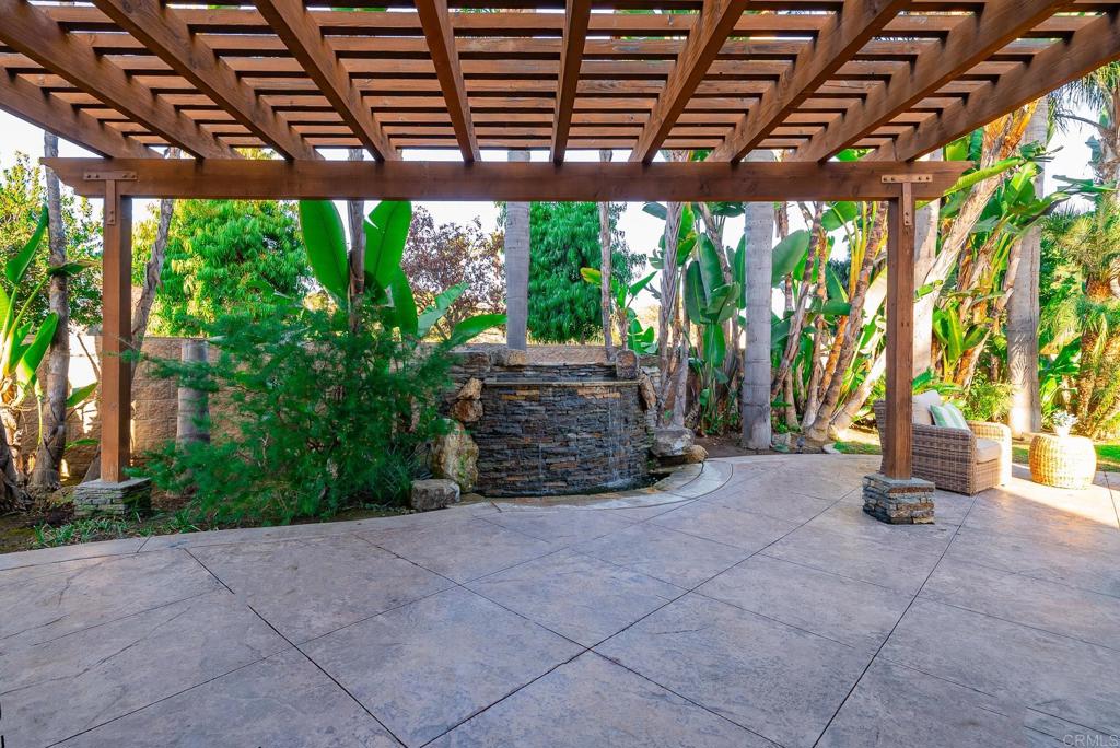 5406 Foxtail Loop Carlsbad, CA 92010 - Photo 38 of 50 a view of a patio with plants and large trees with wooden fence