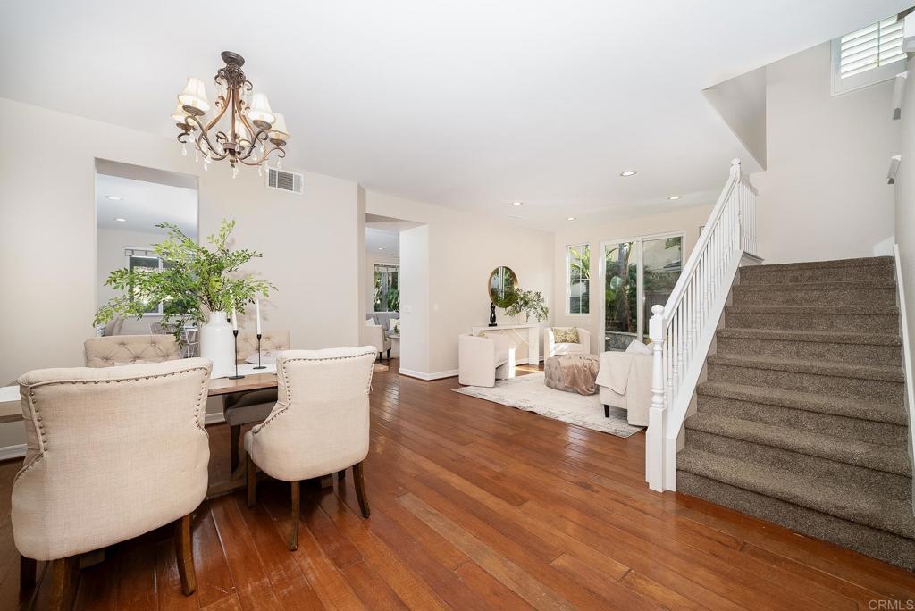 5406 Foxtail Loop Carlsbad, CA 92010 - Photo 4 of 50 a view of a dining room with furniture wooden floor and a chandelier