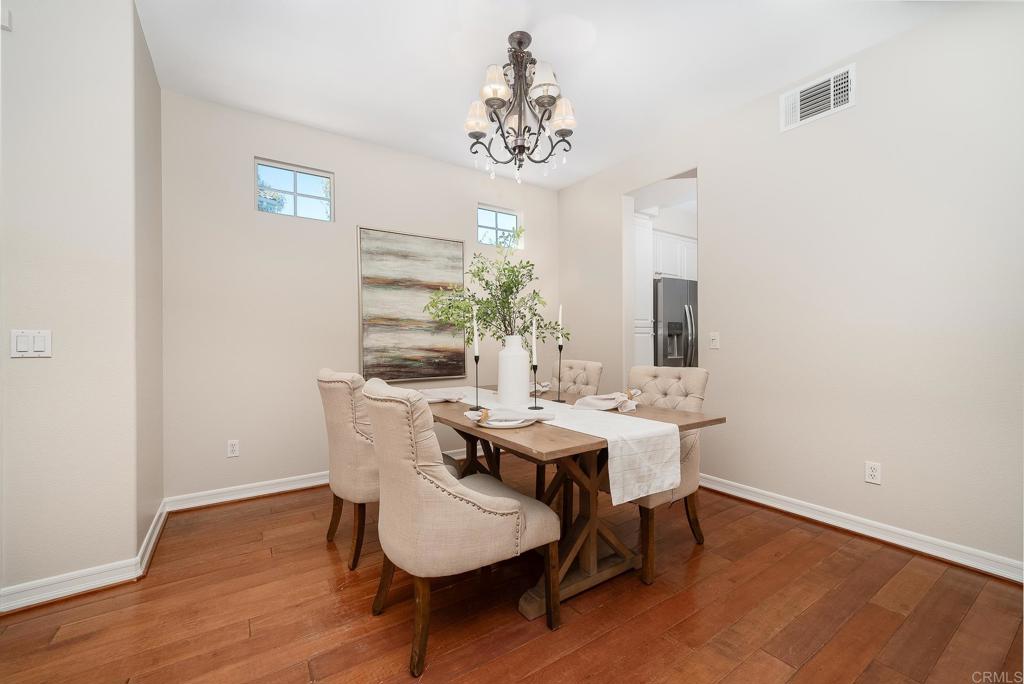 5406 Foxtail Loop Carlsbad, CA 92010 - Photo 5 of 50 a view of a dining room with furniture and chandelier