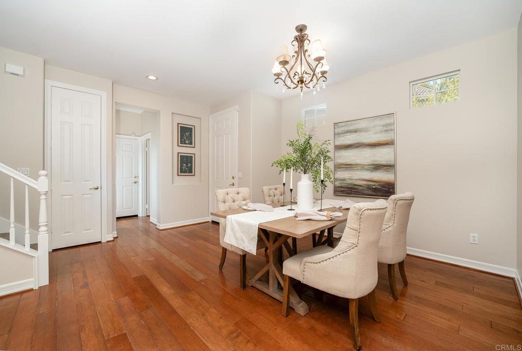 5406 Foxtail Loop Carlsbad, CA 92010 - Photo 6 of 50 a view of a dining room with furniture wooden floor and chandelier