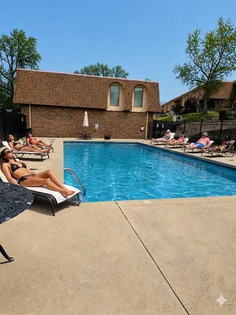a view of a house with pool yard and outdoor seating