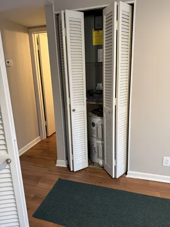 an empty room with wooden floor and a window