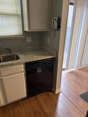 a kitchen with a stove microwave and sink