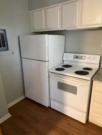 a view of washer and dryer with wooden floor