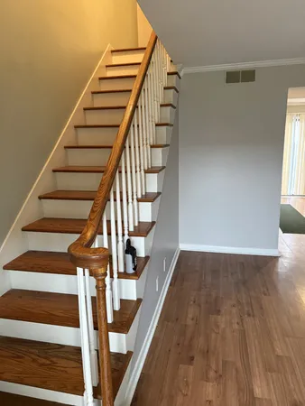 a view of entryway and hall with wooden floor