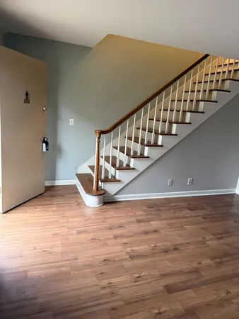a view of entryway and hall with wooden floor